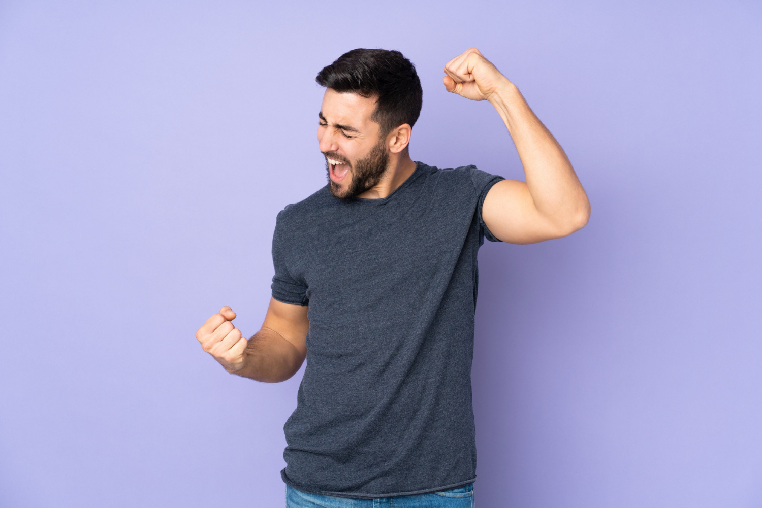 caucasian-handsome-man-celebrating-victory-isolated-purple-wall