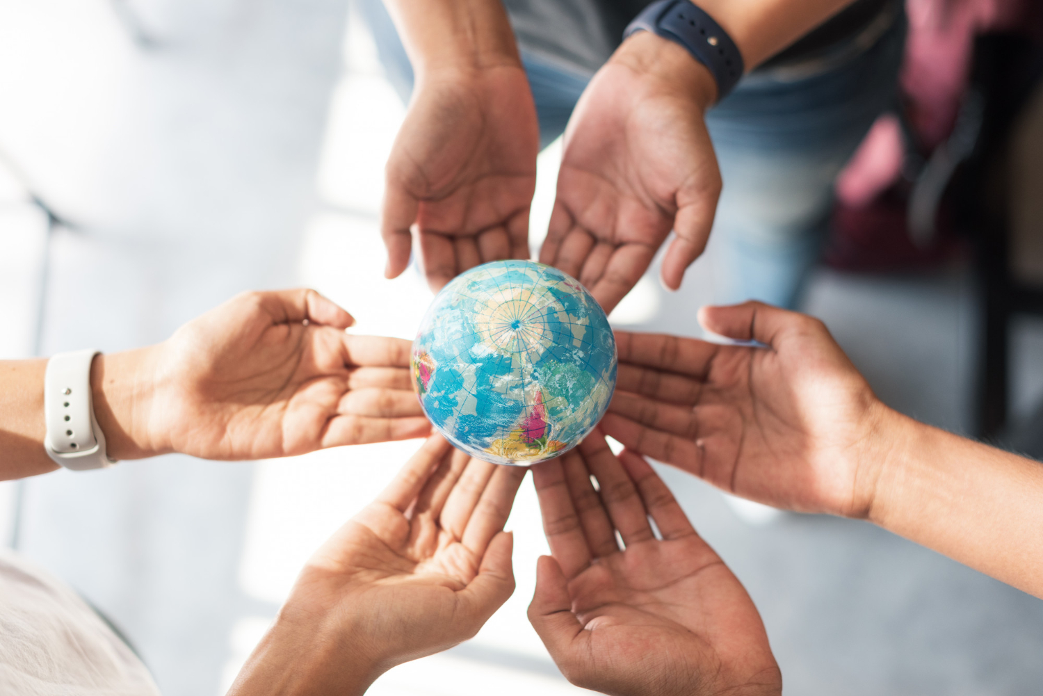 hands-holding-small-globe