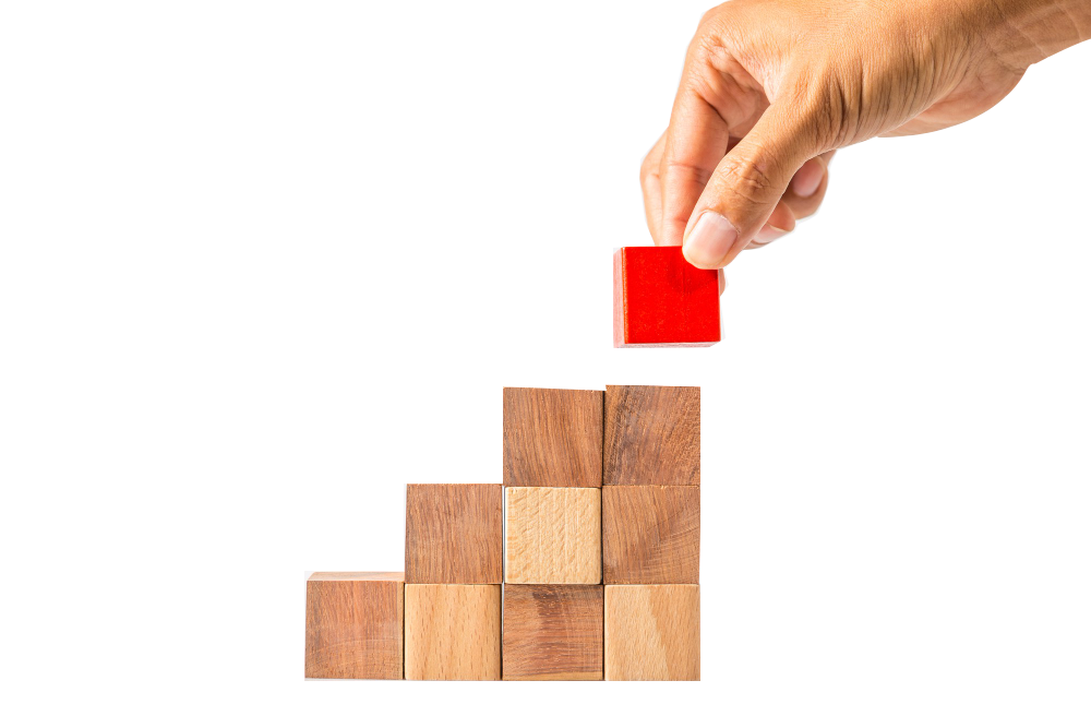 hand-adding-last-missing-wooden-block-into-place-business-success-concept